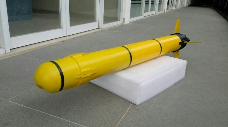 The yellow torpedo-shaped HUG Arnadyaksa vehicle with tail fins, resting on a stand
